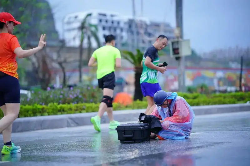 Poncho on, camera covered, still at the post